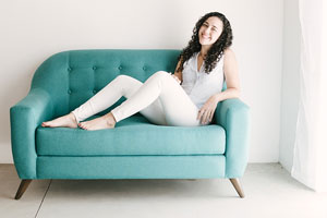 barefoot woman relaxing on a teal couch