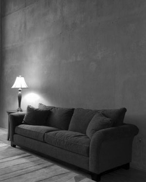 brown couch, end table, and table lamp