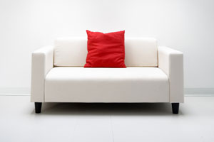 white love seat with red pillow